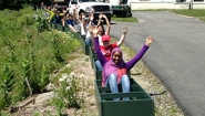 botanic garden students in empty raised bed boxes