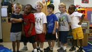 preschoolers pose in their school
