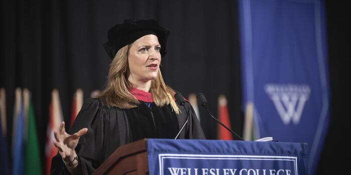 Michigan Secretary of State Jocelyn Benson speaks from behind podium at Wellesley College commencement