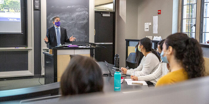 a person talking to a group of students