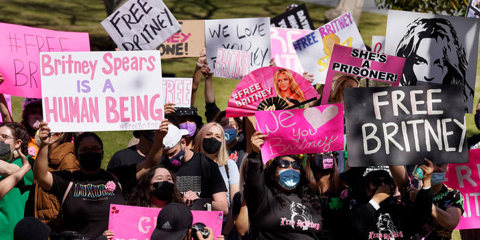 Britney Spears fans hold signs outside a Los Angeles court hearing concerning the pop singer’s conservatorship on March 17, 2021