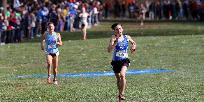 Senior Ari Marks sprints toward the finish line during a cross country competition.