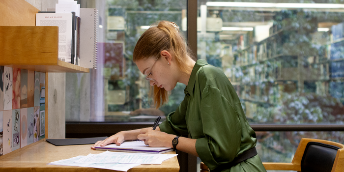 Clara Chambers ’24 studies at her thesis carrel in the library.