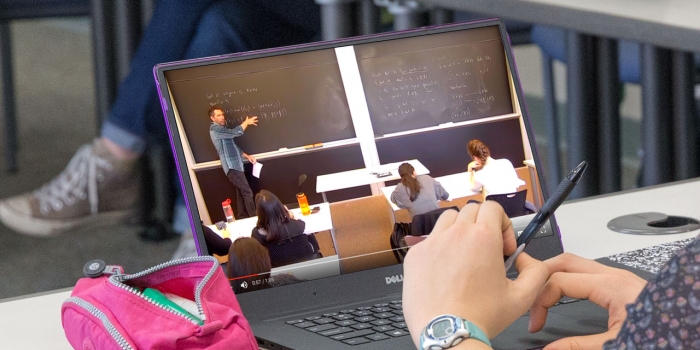 Student watches class on her laptop