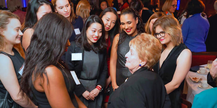 Madeleine K. Albright talking with students at an Albright Institute event.