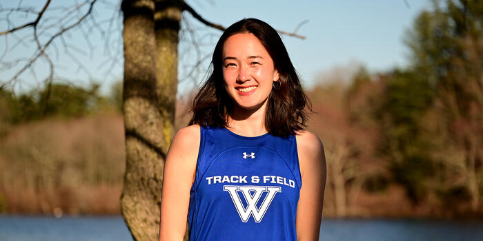 Ellie Murphy-Weise ’23 poses for a portrait in the late afternoon sun near Lake Waban.