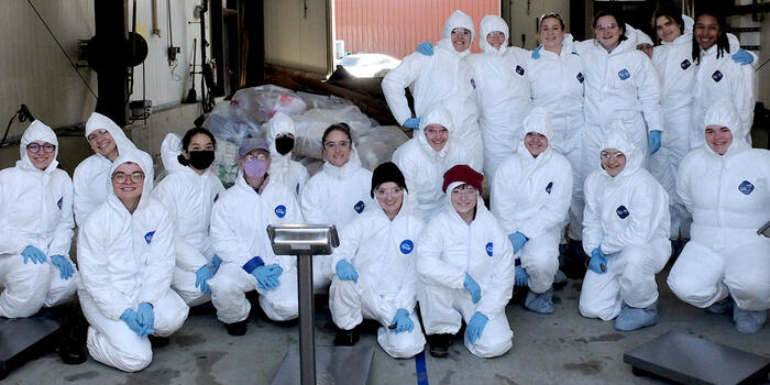 Students pose in their hazmat suits.