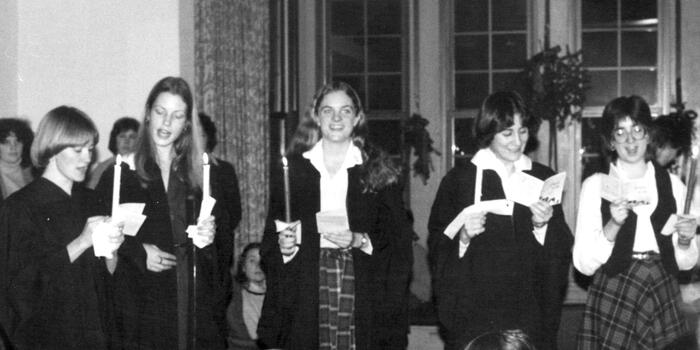 Vintage photo from 1980 showing students holding candles and singing for holidays.