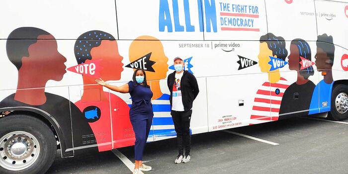 joy stiles and another person standing in front of a bus