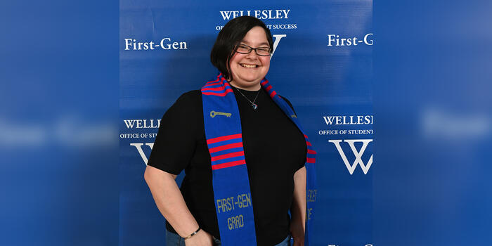 Mikhaela Andersonn poses with her First-Gen stole around her shoulders. 