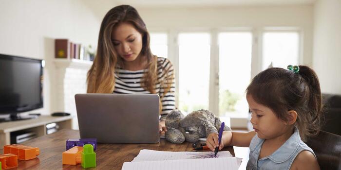 mom working from home with young child