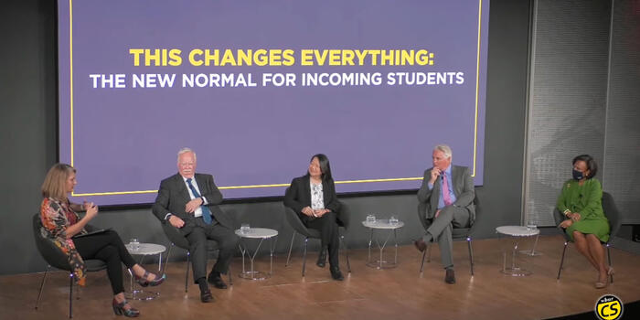 panelists sit on a stage