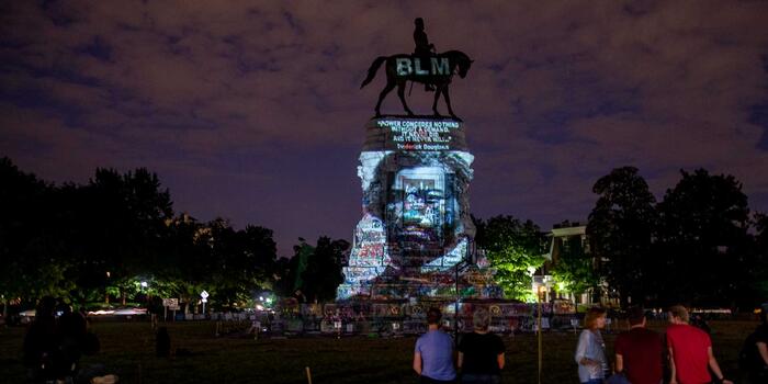 Frederick Douglass’ image is projected on the Robert E. Lee Monument