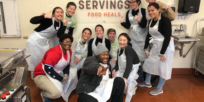 A group photo of students at Community Servings, a Boston nonprofit that cooks and delivers food.