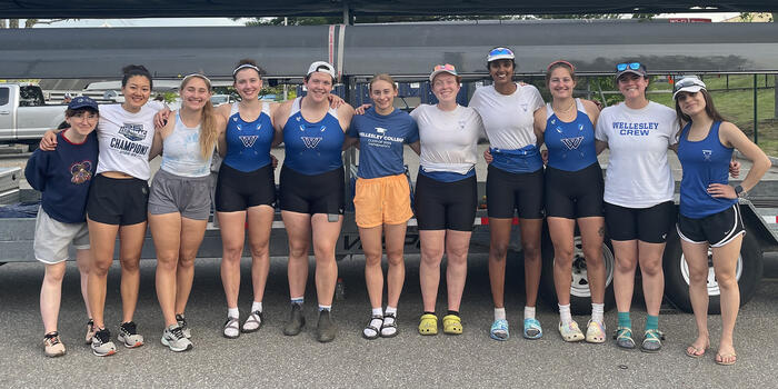 The eleven seniors from the crew team pose together with arms around each othe