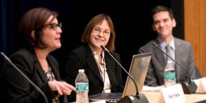 Sari Kerr sits at a panel presentation.