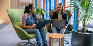 Two students sit at a table in the science center.