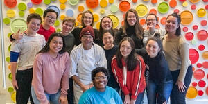 a group of students stand smiling together