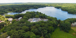 An ariel photo of campus with Lake Waban in the distance