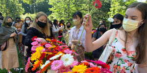people picking up colorful flowers