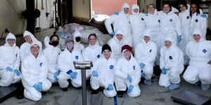Students pose in their hazmat suits.