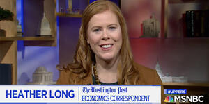 A woman speaks to a camera.