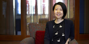 Portrait of professor Heng Du sitting in an armchair.