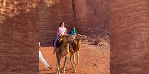collage of students on camels in the desert of Jordan