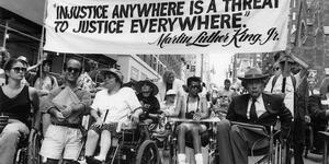 black and white photo of disability rights activists demonstrating