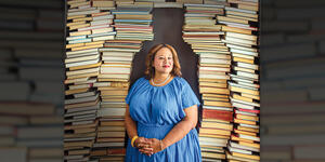  Jasmine Guillory ’97 photographed in front of stacks of books.