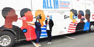 joy stiles and another person standing in front of a bus