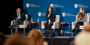 Linda Charmarman speaking on stage at an event.