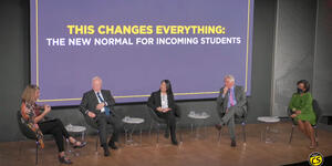 panelists sit on a stage