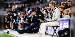 Olivia Reckley ’20 sits on the sidelines, working on her computer.