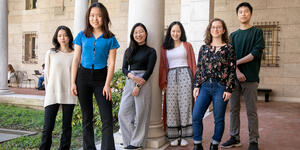 Five women and one man stand together for a group photo. 