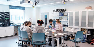 Neuroscience students work together in a spacious lab filled with natural light.