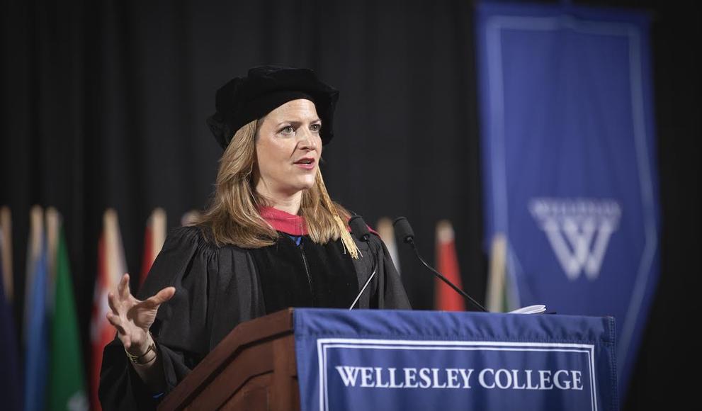 Michigan Secretary of State Jocelyn Benson speaks from behind podium at Wellesley College commencement
