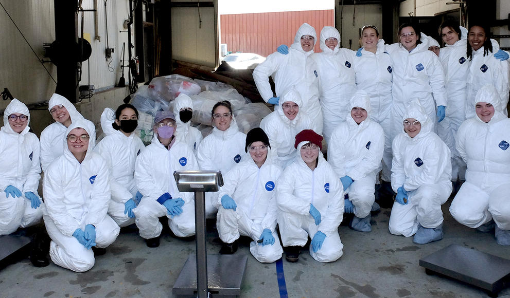 Students pose in their hazmat suits.