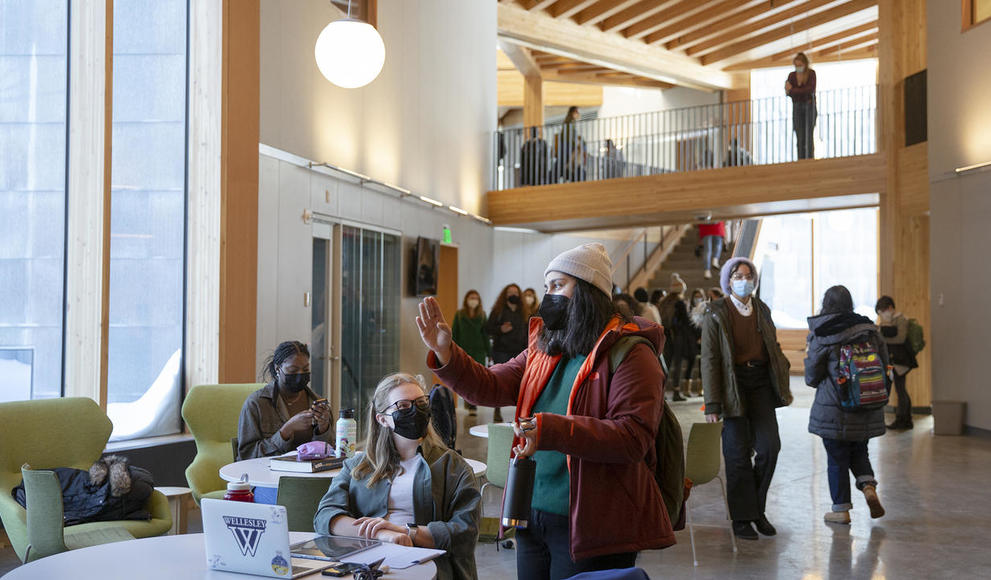 Two students wearing face masks talk to each other in Wellesley's new Science Complex.