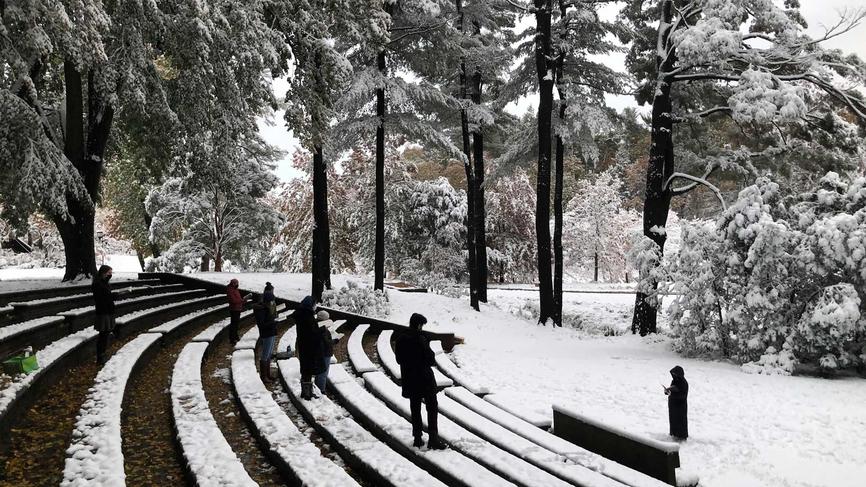 people standing in the snow in the hay outdoor theater