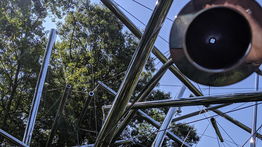 A close shot of a sculpture made up of stainless steel tubes.