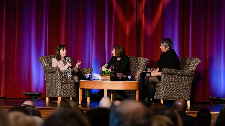Two professors moderate a Q&A on stage with Jane Mayer