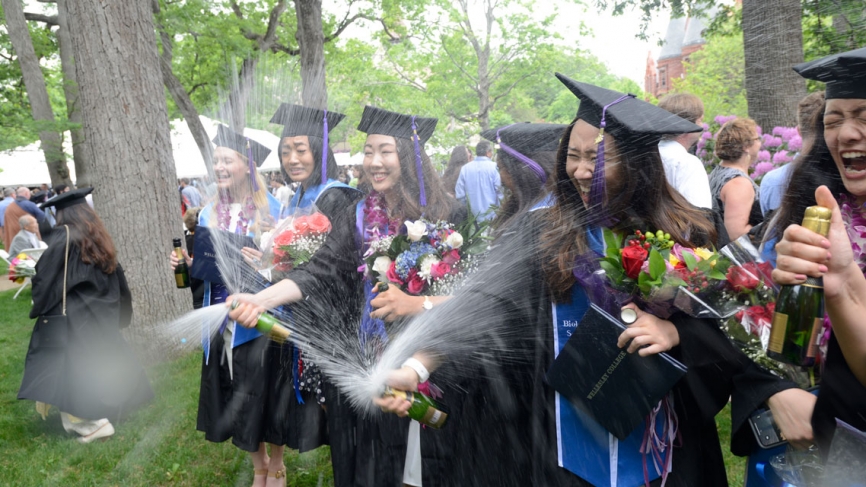 Members of the class of 2018 celebrate their graduation with Champagne.