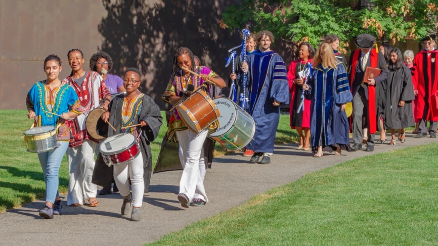 Students with drums lead the convocation procession from the Campus Center to Alumnae Auditorium. 