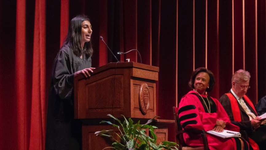 Student speaker Maya Nandakumar gives her address to the student body as President Johnson and Provost Shennan look on.