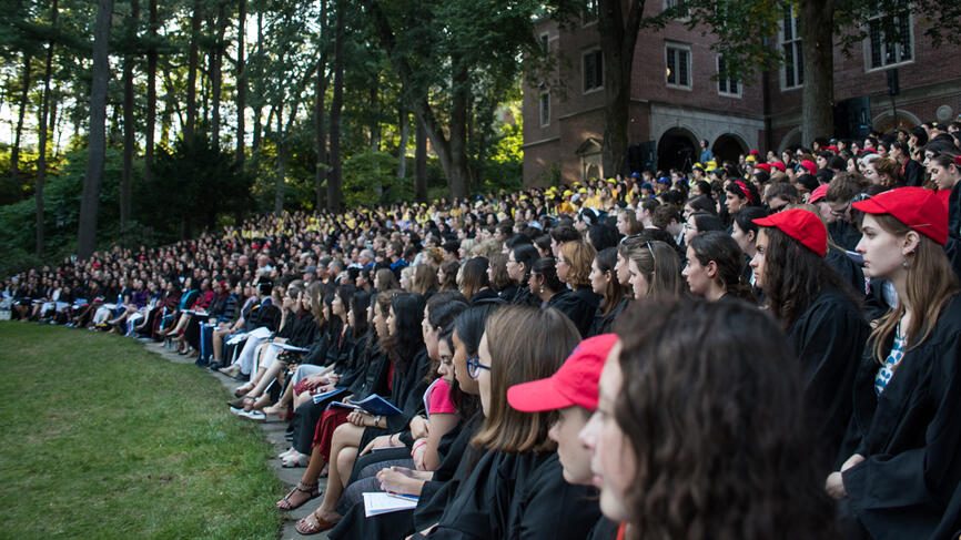 Students sit in Hay Amphitheater listening to remarks.  