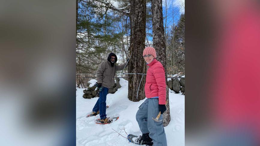 two people in the woods in the snow