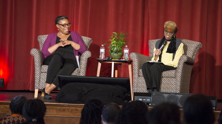 Mfoniso Udofia '06 and Lois P. Roach speak on stage.