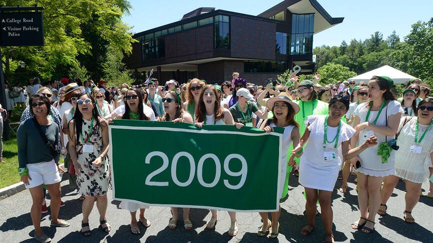 Members of the green class of 2009 stand behind their class banner in front of LuLu