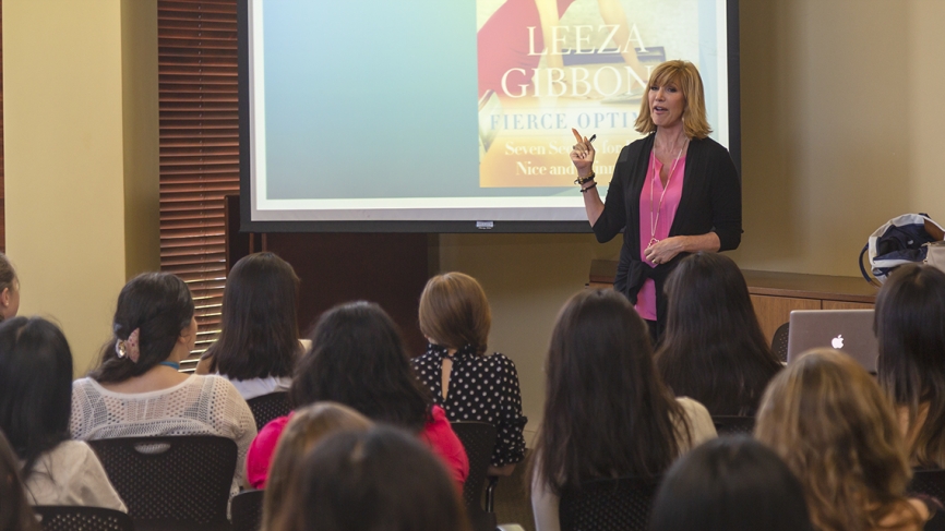 Leeza Gibbons stands at the front of a lecture hall speaking to summer program recipients.